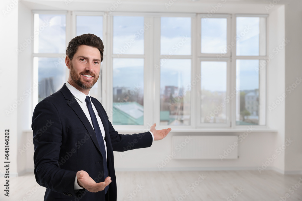 Happy real estate agent showing new apartment. Space for text Happy real estate agent showing new apartment. Space for text