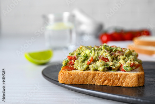 Delicious sandwich with guacamole on white table, closeup. Space for text