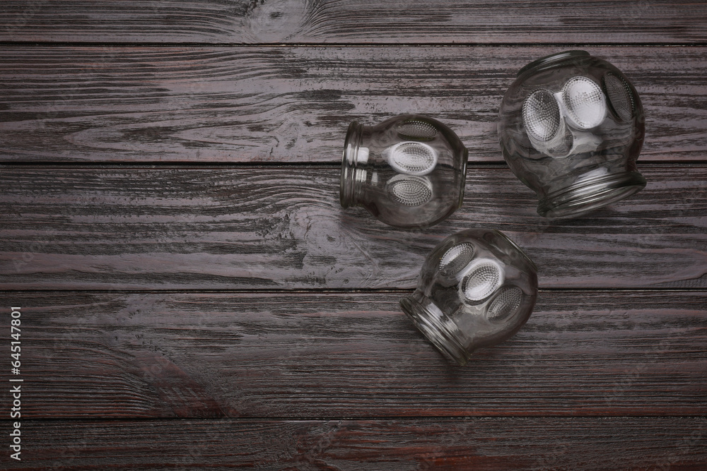 Cupping therapy. Glass cups on wooden table, flat lay with space for text Cupping therapy. Glass cups on wooden table, flat lay with space for text