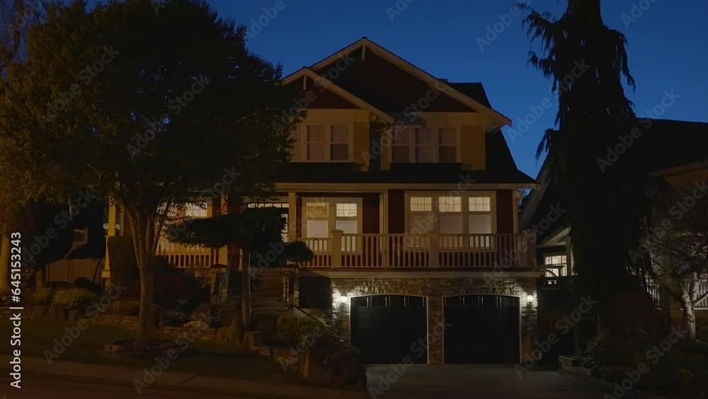Establishing shot of two story stucco luxury house with garage door, big tree and nice landscape at night in Vancouver, Canada, North America. Night time on Apr 2023. ProRes 422 HQ. Establishing shot of two story stucco luxury house with garage door, big tree and nice landscape at night in Vancouver, Canada, North America. Night time on Apr 2023. ProRes 422 HQ.
