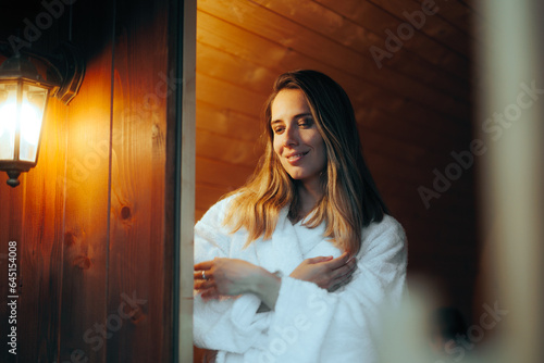 Happy Woman trying a Sauna Relaxing on Vacation. Beautiful girl enjoying wellness therapy in a hot house 