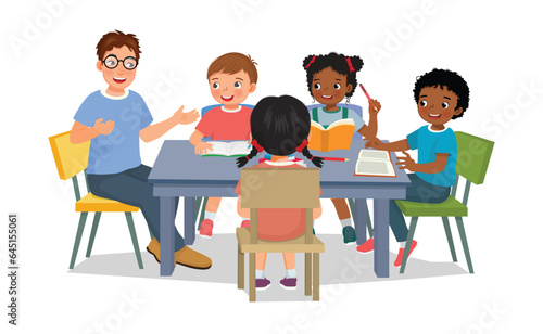 Male teacher teaching explaining and discuss lesson with his students at the table
