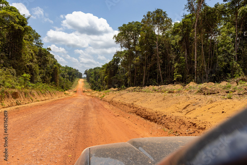 Driving on the famous earth road Transamazonica towards Santarém through the Amazon rainforest in dry season in northern Brazil, South America photo