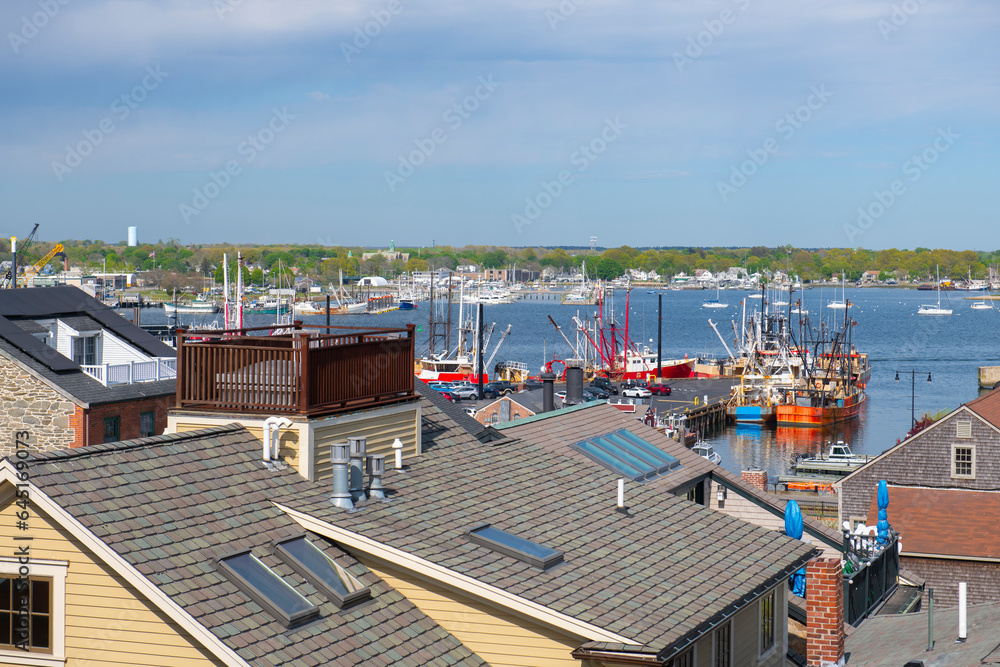 Fototapeta premium New Bedford harbor aerial view with fishing boats docked at piers near historic downtown of New Bedford, Massachusetts MA, USA.
