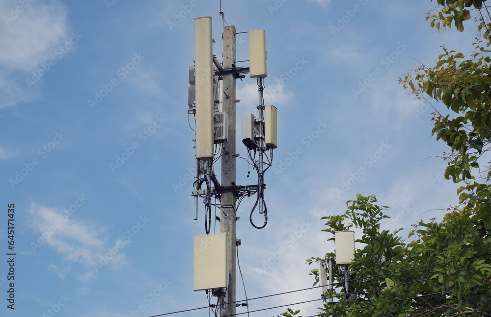 Telecommunication tower of 4G and 5G cellular. Macro Base Station. 5G radio network telecommunication equipment with radio modules and smart antennas mounted on a metal against cloulds sky background. Telecommunication tower of 4G and 5G cellular. Macro Base Station. 5G radio network telecommunication equipment with radio modules and smart antennas mounted on a metal against cloulds sky background.