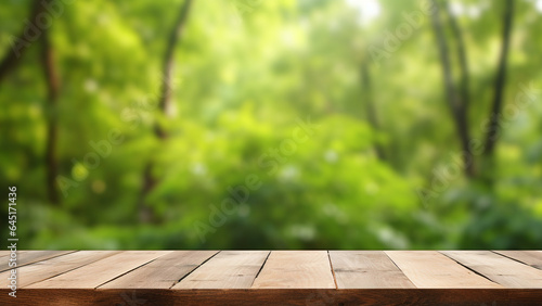 blank wooden plank on blur green forest background. empty table top for nature banner and poster backdrop