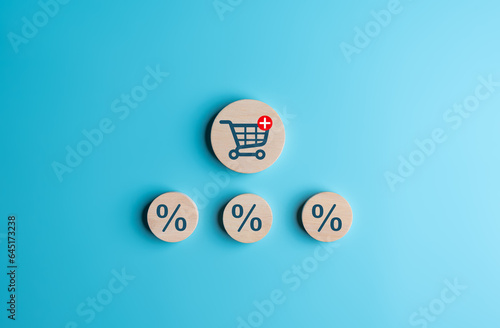 Shipping trolley cart and percentage icons on wooden circles for delivery discount concept. Increase higher sale volume for online e-commerce business marketing by promotion and strategy.