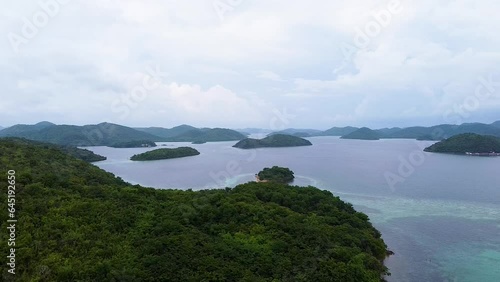 Wallpaper Mural Aerial drone lowering toward tropical island covered in trees and rainforest with scattered islands in remote Coron Bay, Palawan, Philippines Torontodigital.ca