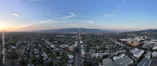 Wide aerial panorama of Burbank, CA looking north towards the Verdugo Mountains at sunset