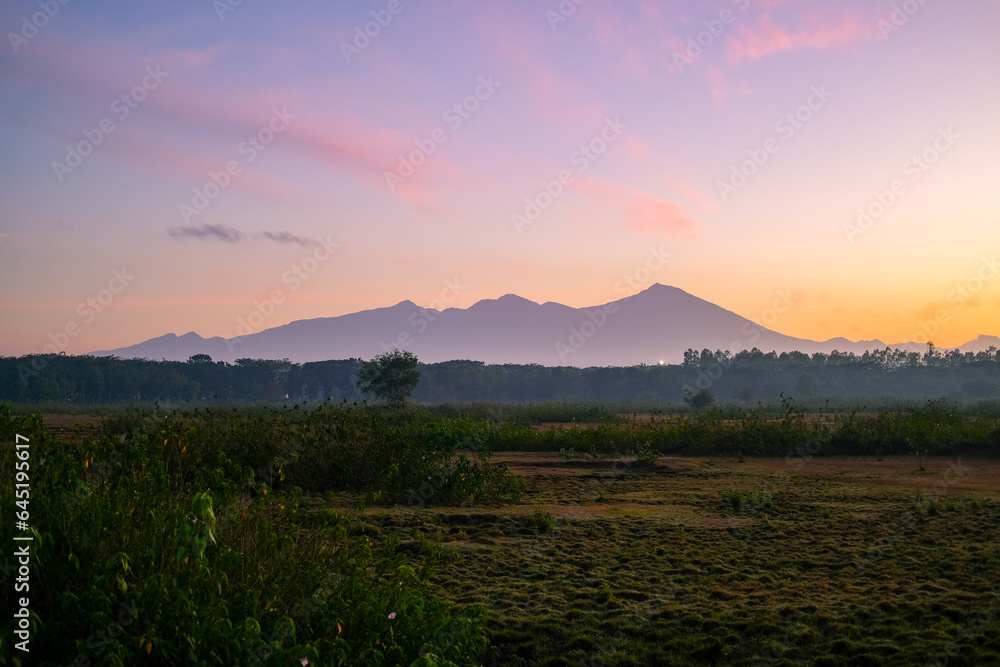 view of Mount Rinjani at sunrise in Lombok, sunrise and mountain view, sunrise in Lombok, sunrise over the mountains, mount Rinjani view in the morning, beautiful sunrise sky and mountain