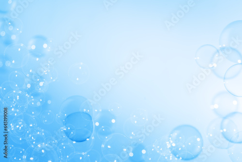 Refreshing of Soap suds, Bubbles Water. Beautiful Transparent Blue Soap Bubbles Floating in The Air. Abstract Blurred Background, Gradient Blue Textured, Celebration Festive Backdrop.