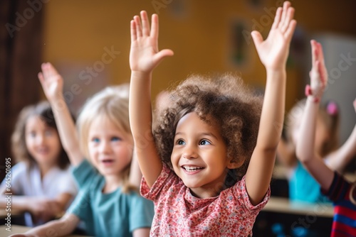 Group of children raising hands in classroom at school. Education and back to school concept