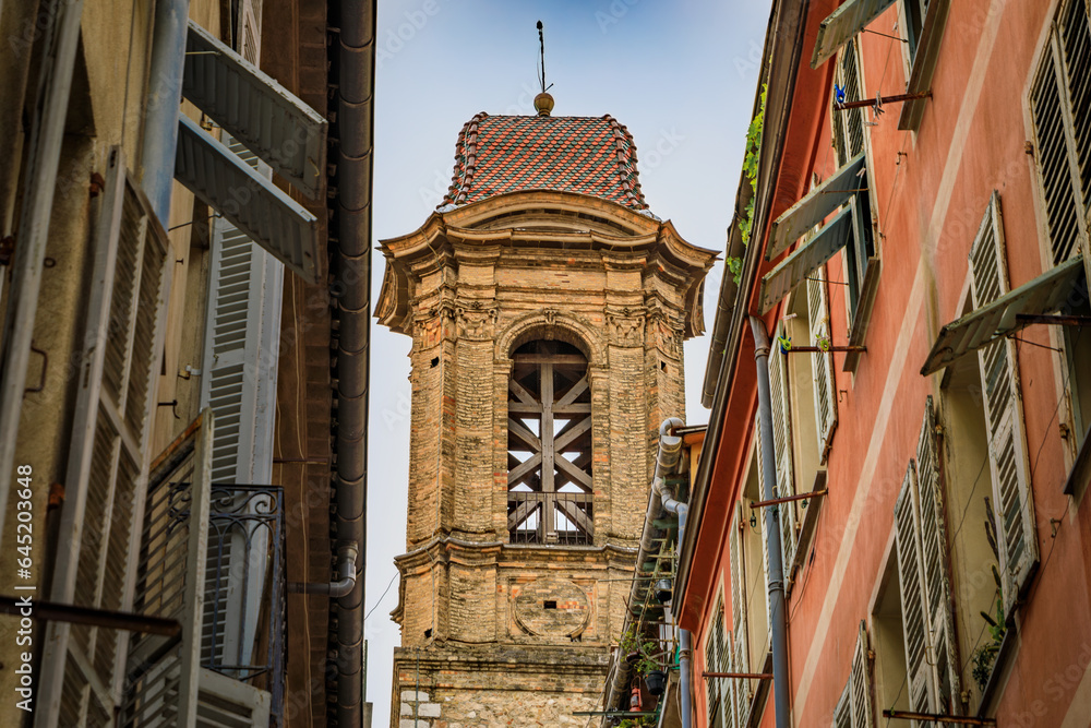 Bell tower of the Jesuits chapel or Church of Saint Jacques le Majeur and traditional mediterranean house facades in the streets Old Town Nice, France