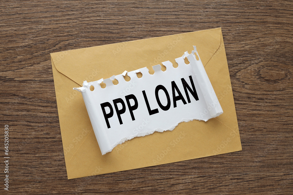 Paycheck Protection Program PPP Loan. envelope on the desk.. text on torn paper Paycheck Protection Program PPP Loan. envelope on the desk.. text on torn paper
