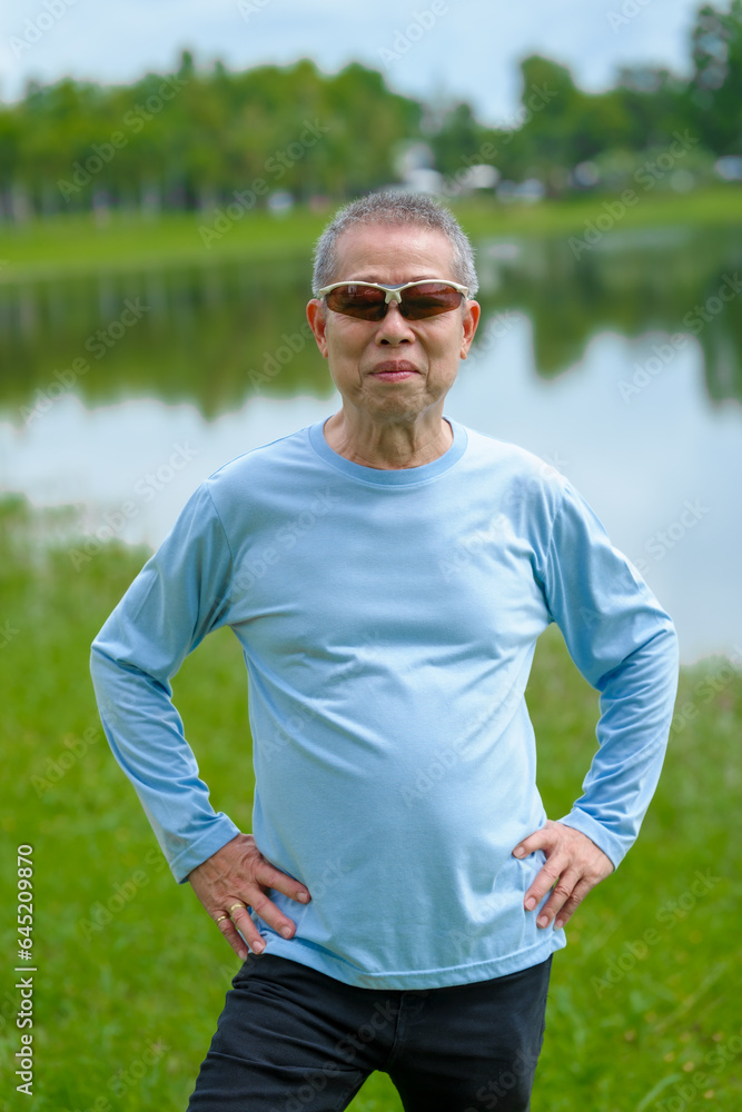Happiness in nature, elderly asian man in blue shirt blissful time in the park, nature's comfort, parkside relaxation, peaceful moments, refreshing break Happiness in nature, elderly asian man in blue shirt blissful time in the park, nature's comfort, parkside relaxation, peaceful moments, refreshing break