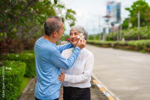 Elderly love, couple relaxing outdoors in blissful family time, peaceful moments, Mature asian husband and wife family time in natural serenity, heartwarming, relaxation