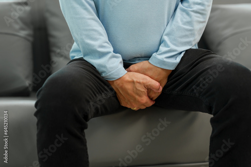 Senior Asian man on the sofa, with sexual dysfunction. Erectile Dysfunction (ED)