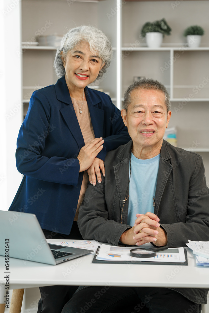 Asian senior man and woman collaborating in small medium enterprises working together. Couple business family, Elderly people Asian senior man and woman collaborating in small medium enterprises working together. Couple business family, Elderly people