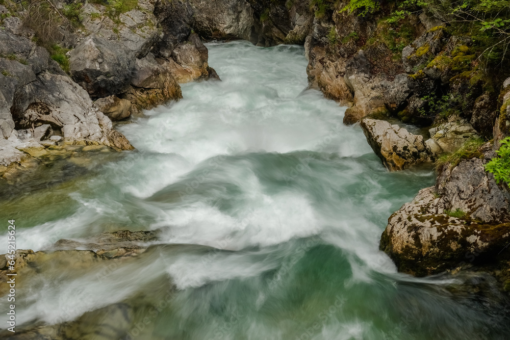fast flowing torrent between rocky walls