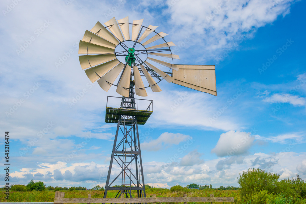 Wind motor in wetland in sunlight in summer, De Alde Feanen, Earnewald, Friesland, Netherlands, August, 2023 Wind motor in wetland in sunlight in summer, De Alde Feanen, Earnewald, Friesland, Netherlands, August, 2023