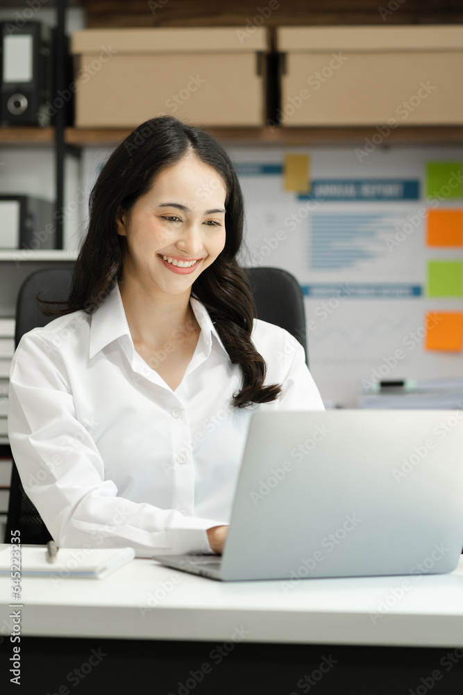Women work on laptop on the table at the office with information documents. Women work on laptop on the table at the office with information documents.