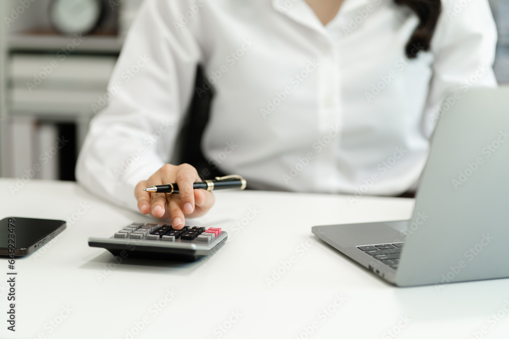 Hand women doing finances and calculate on desk about cost at home office. Hand women doing finances and calculate on desk about cost at home office.