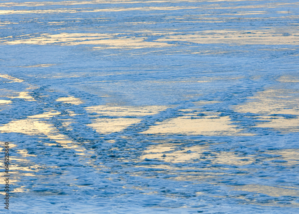 Snow on the lake in winter in the rays of sunset. Snow on the lake in winter in the rays of sunset.