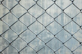 Rust proof galvanized steel mesh fence against concrete wall background.