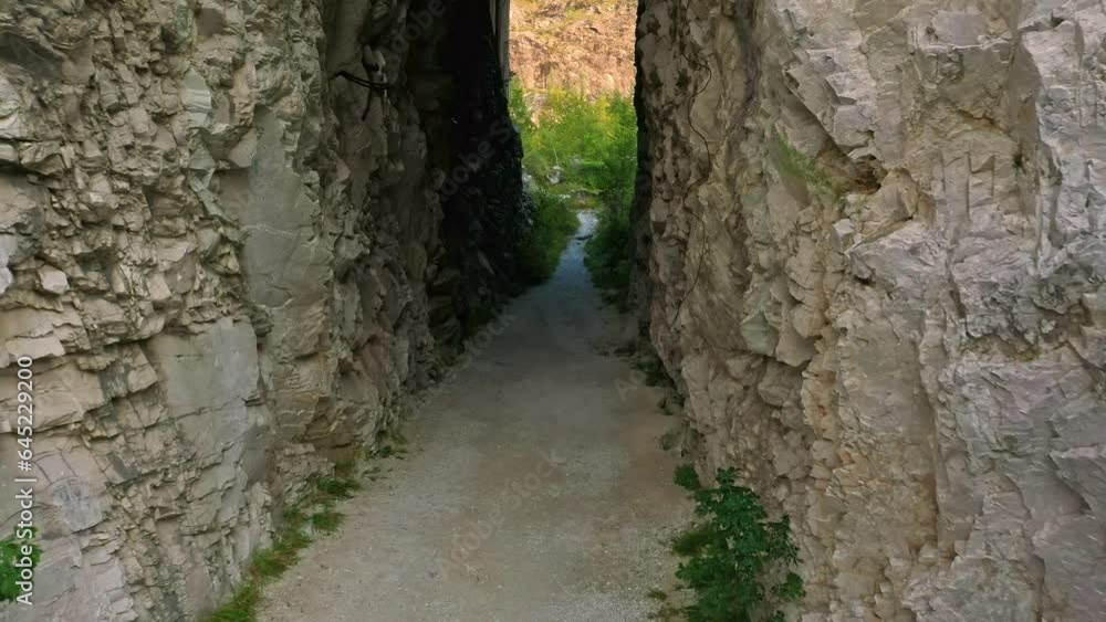 Drone fly through rock-cut entrance of abandoned marble quarry in Drone fly through rock-cut entrance of abandoned marble quarry in
