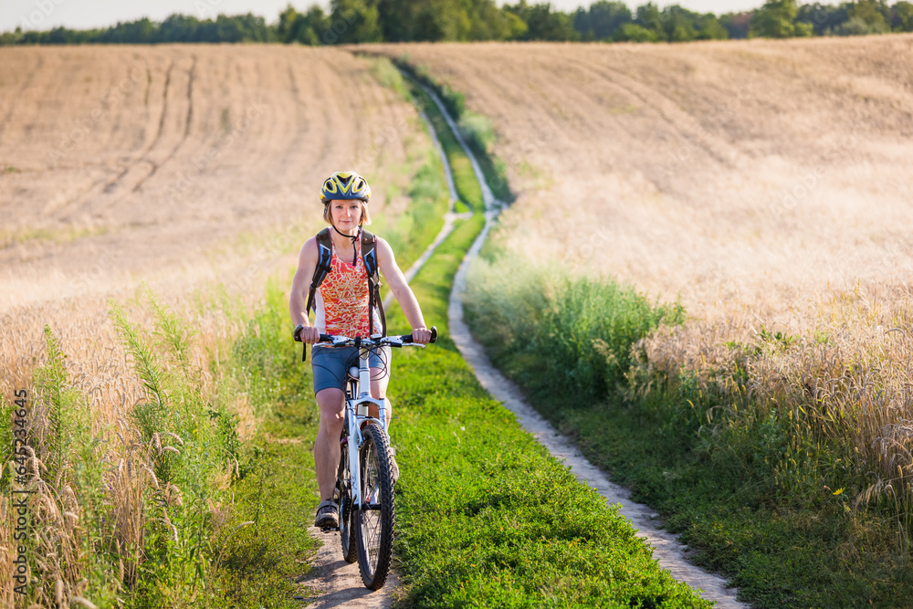 Obraz premium Happy Young Woman riding bicycle outside. Healthy Lifestyle
