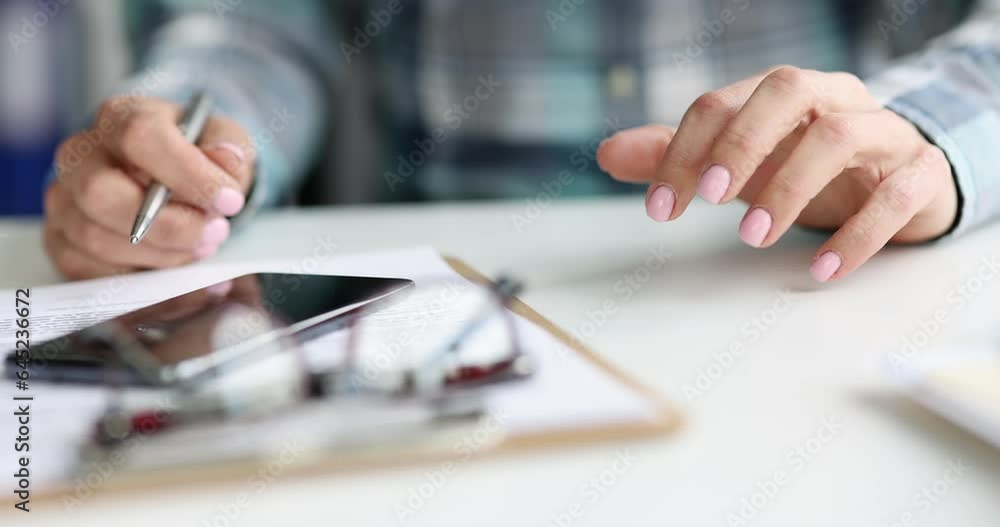 Closeup of woman hand with pen tapping fingers on table anxiously working in office. Anxiety stress and boredom concept Closeup of woman hand with pen tapping fingers on table anxiously working in office. Anxiety stress and boredom concept