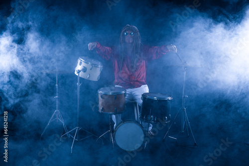 male drummer plays drums on a black background