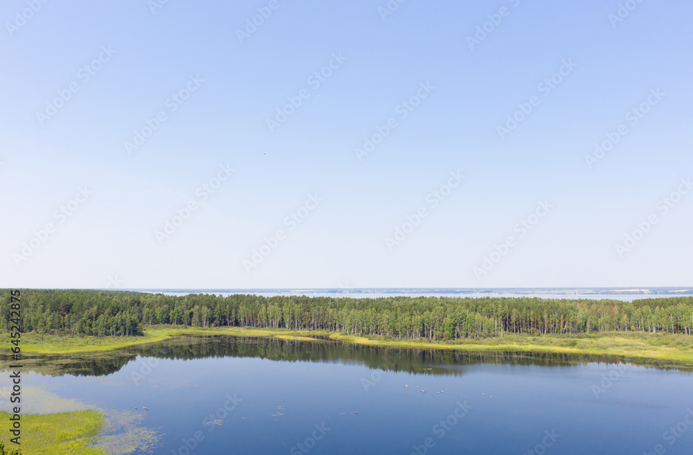 Aerial photo of forest boggy lake in the Karakansky pine forest near the shore of the Ob reservoir.
