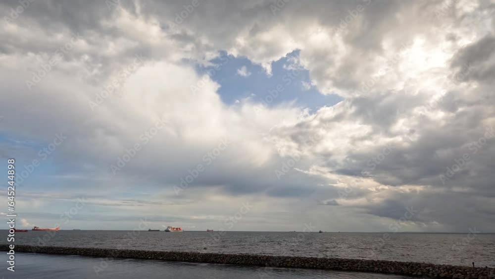 Dramatic sky. The sea, the horizon. Timelapse. Time lapse of fast flying clouds in the sky. Big sun sets behind the clouds and the horizon. Dramatic sky. The sea, the horizon. Timelapse. Time lapse of fast flying clouds in the sky. Big sun sets behind the clouds and the horizon.