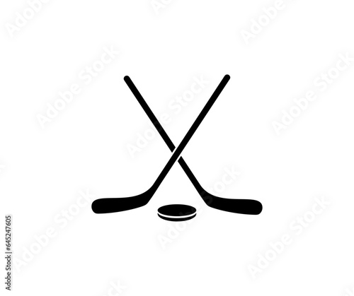 Crossed hockey sticks and puck logo design. Ice hockey sports equipment vector design and illustration.
