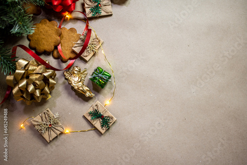 Christmas decoration composition with ribbon, angel, Christmas cookies, top view. Space for copy text.