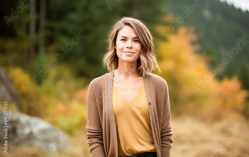 Portrait in the forest of a pleased 30 years old woman. Joyful woman in an outdoor fall scenery having fun at the autumn season. 