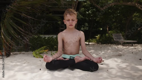 Concept of healthy lifestyle, kid boy daily meditation, relax time, harmony. Maldives islands. Mind practice. High quality 4k footage