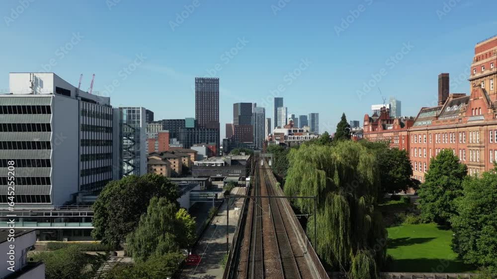 Aerial drone flight along train track from Piccadilly to Oxford Road Train Station giving a skyline view of Elizabeth Tower. Aerial drone flight along train track from Piccadilly to Oxford Road Train Station giving a skyline view of Elizabeth Tower.
