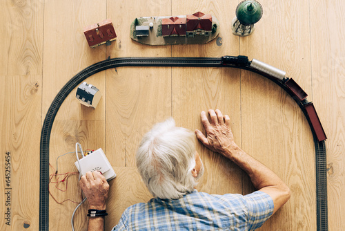 Senior Man Playing With Model Train