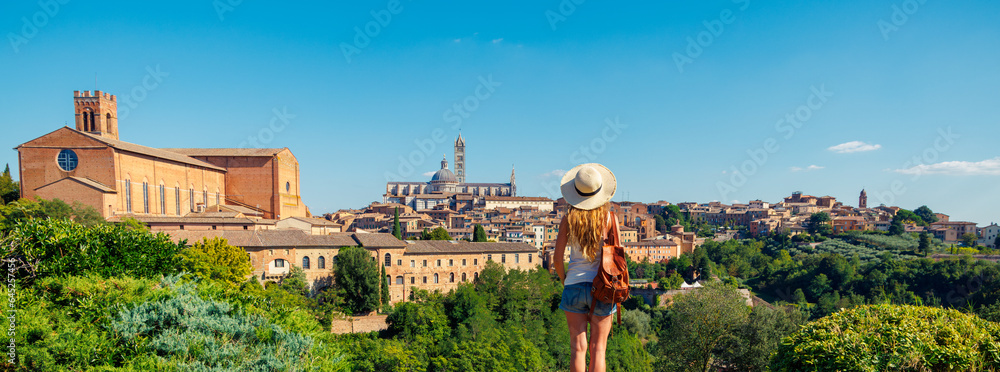 Fototapeta premium Woman tourist looking at panoramic view of Siena cityscape in Italy- tour tourism,travel,vacation in Europe