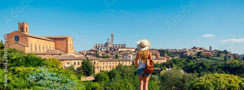 Woman tourist looking at panoramic view of Siena cityscape in Italy- tour tourism,travel,vacation in Europe