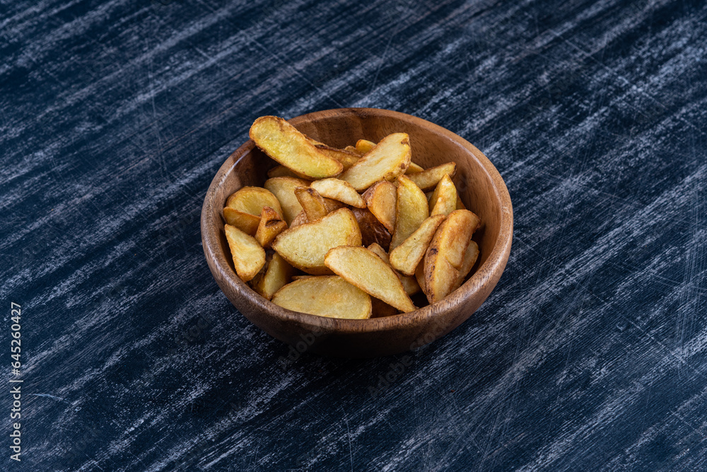 Country fried potatoes on a wooden platter Country fried potatoes on a wooden platter
