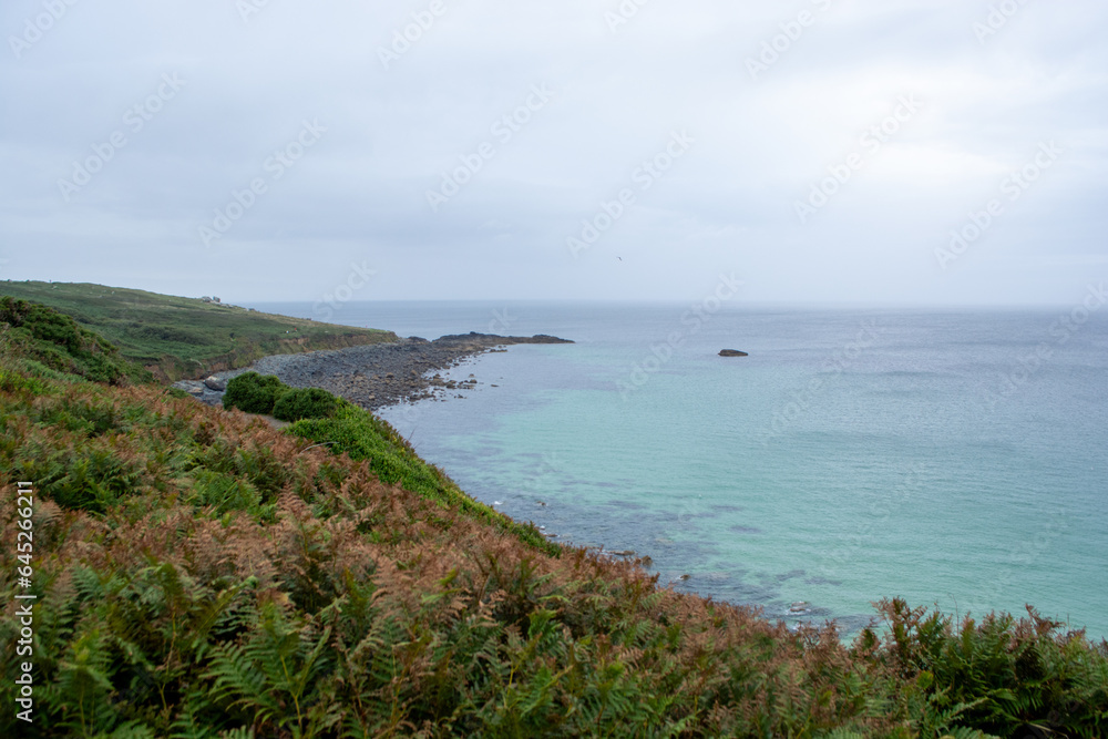 St Ives, Cornwall, UK - August 2023. View of the cliffs and the coast with beach in St. Ives, England, UK. Holidays by the Atlantic Ocean