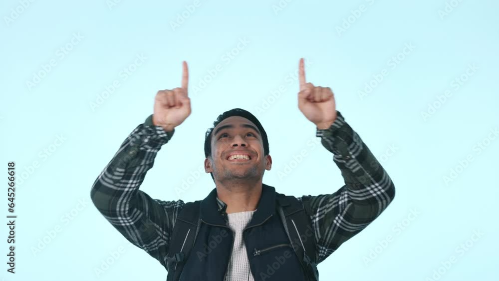 Pointing up, man and face to mockup for marketing, announcement and choice. Advertising decision, male person portrait and happy from promo and offer in studio with blue background and excited model Pointing up, man and face to mockup for marketing, announcement and choice. Advertising decision, male person portrait and happy from promo and offer in studio with blue background and excited model