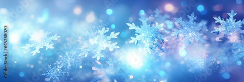 Defocused Christmas background with snowflakes and bokeh lights.  © Slava