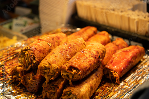 Grilling barbecue meatloaf rolled with vegetables at traditional night market in South Korea. photo