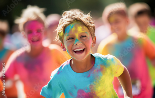Smiling kids covered in colour during a colour run.