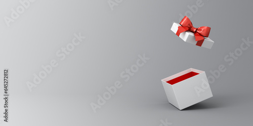 Blank white present box open or gift box with red ribbons and bow isolated on dark white grey background with shadow and blank space minimal conceptual 3D rendering