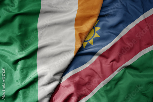 big waving national colorful flag of ireland and national flag of namibia .